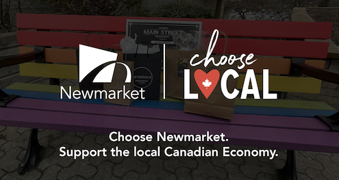 Rainbow bench with Newmarket and Choose Local logos.