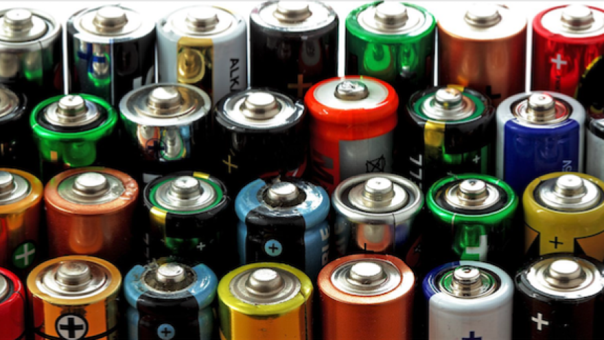 A variety of colorful batteries lined up in rows.