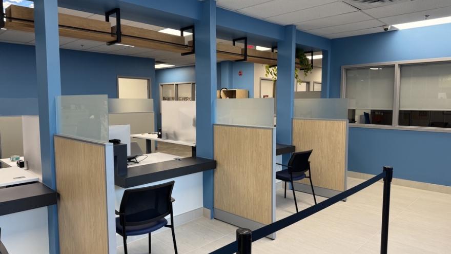 Customer service counter with chairs and line for waiting residents