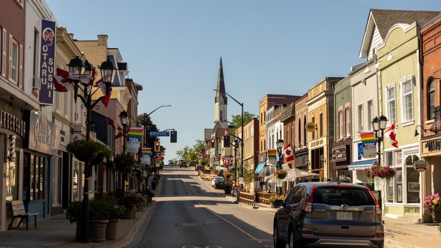 Main Street Newmarket with car driving on road during a sunny day