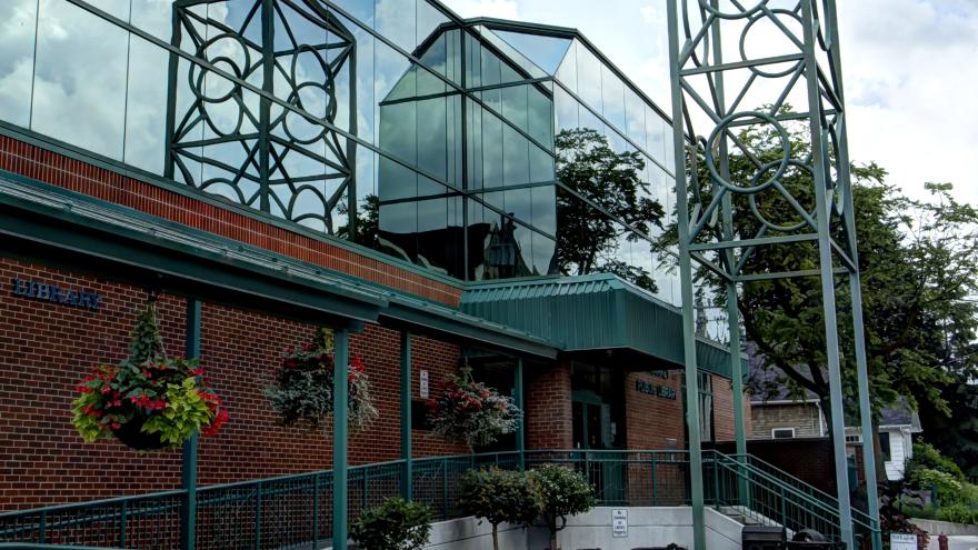Newmarket Public Library building with a cloudy sky