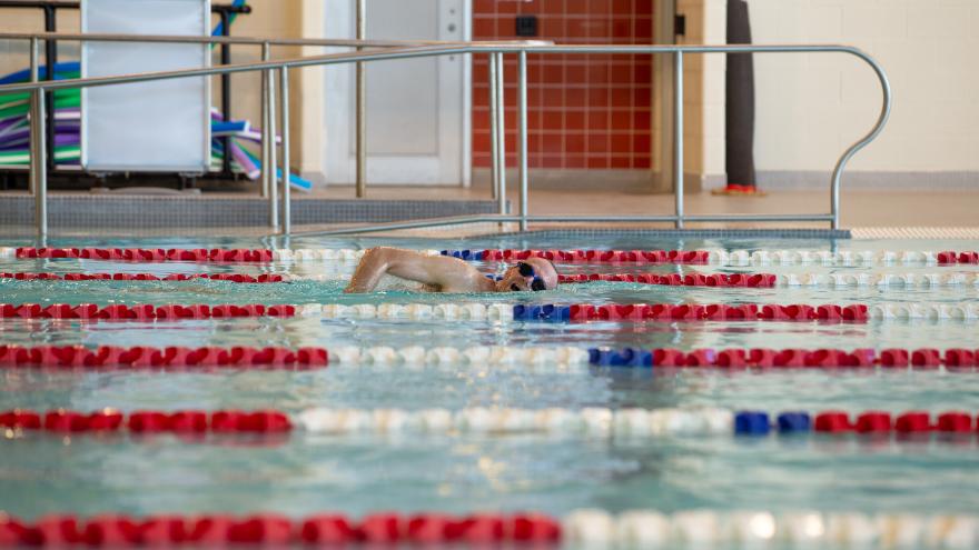 Swimmer doing laps in an indoor pool