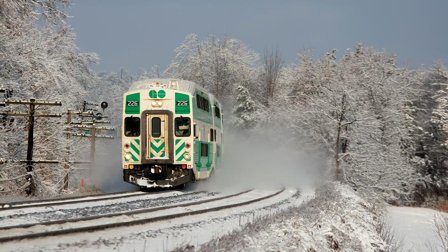 Green Train on Tracks in a clear winter day