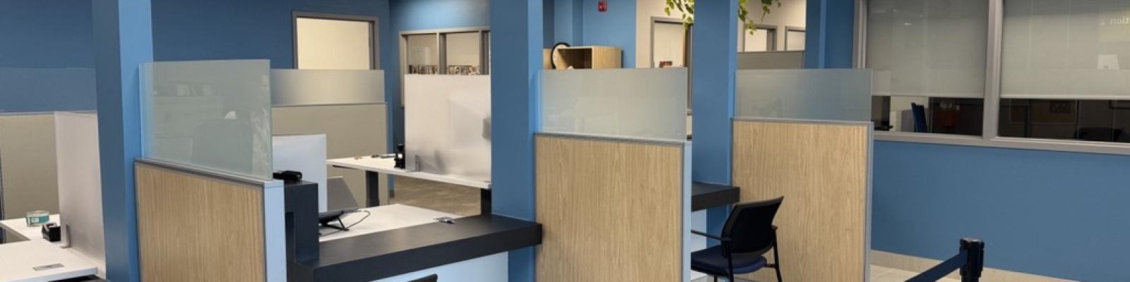 Customer service counter with chairs and line for waiting residents