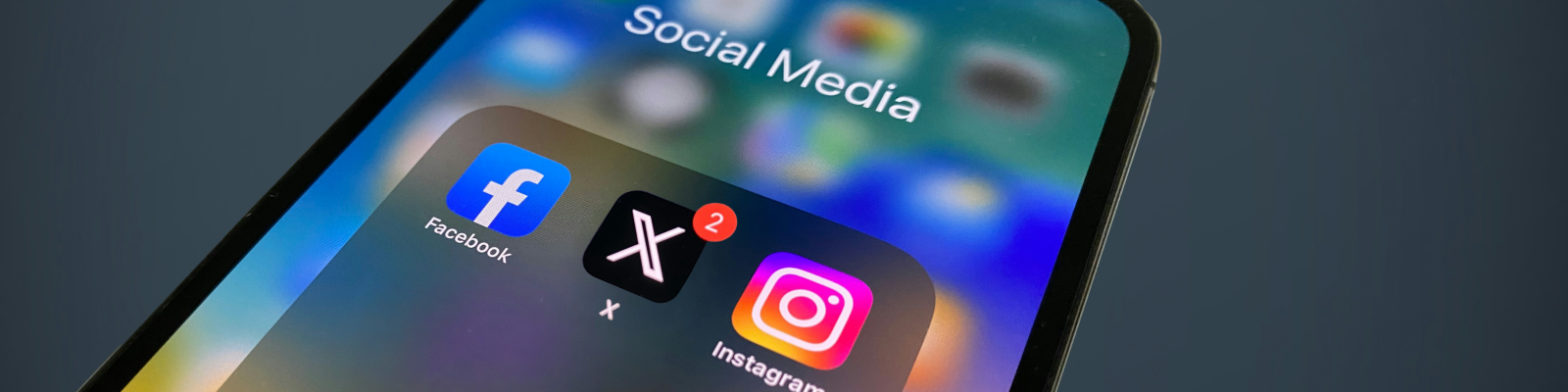 iphone screen showing the facebook, X and instagram apps