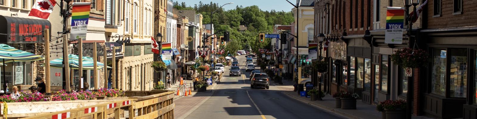 Newmarket main street on a sunny day with shops and people walking
