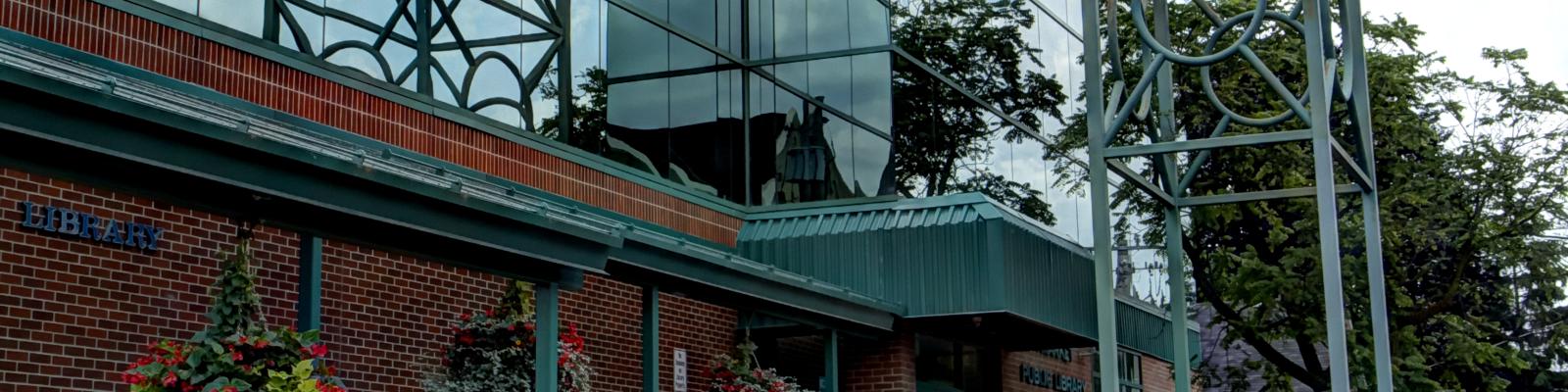 Newmarket Public Library building with a cloudy sky