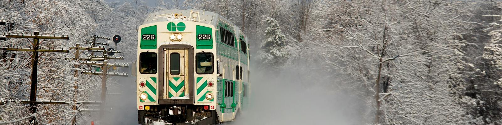Green Train on Tracks in a clear winter day