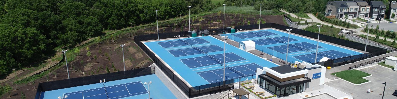 Aerial view of an outdoor tennis facility with multiple courts