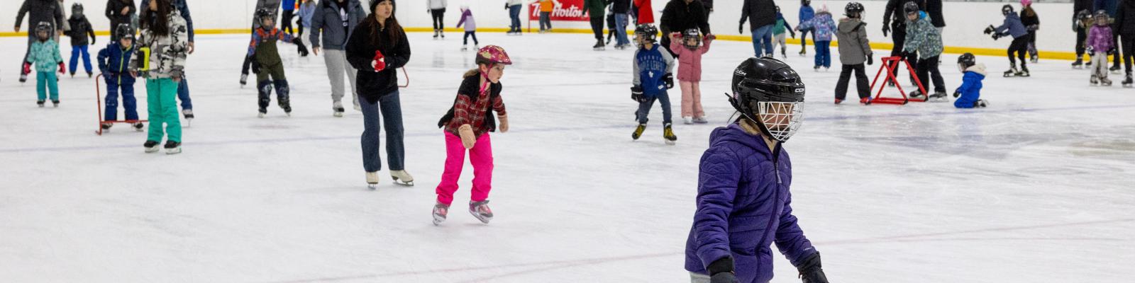 People skating on an indoor ice rink