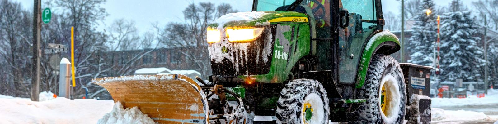 tractor clearing snow from sidewalk