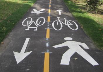 Shared path with bike and pedestrian symbols, divided by a yellow line.