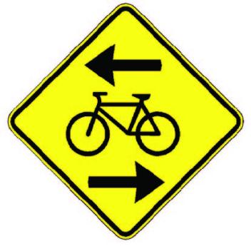 Yellow road sign with arrows and bicycle symbol.