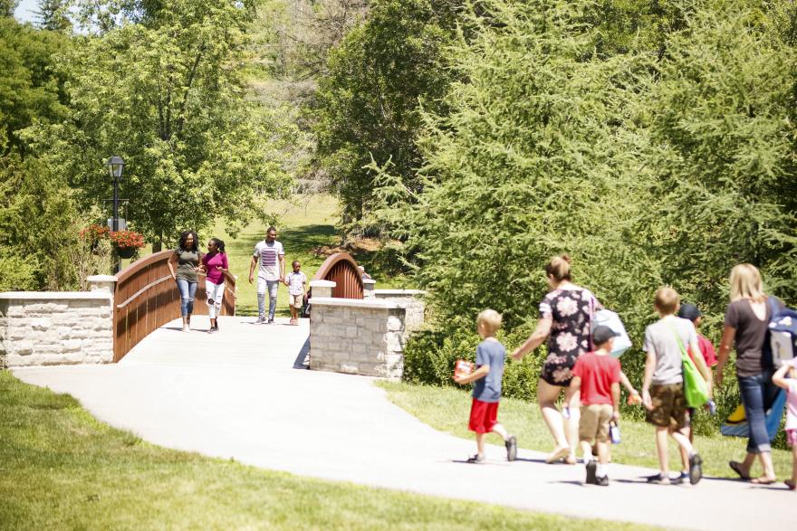 People walking along a green trail