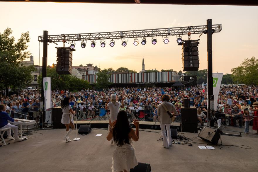 Music artists on stage in front of a large audience