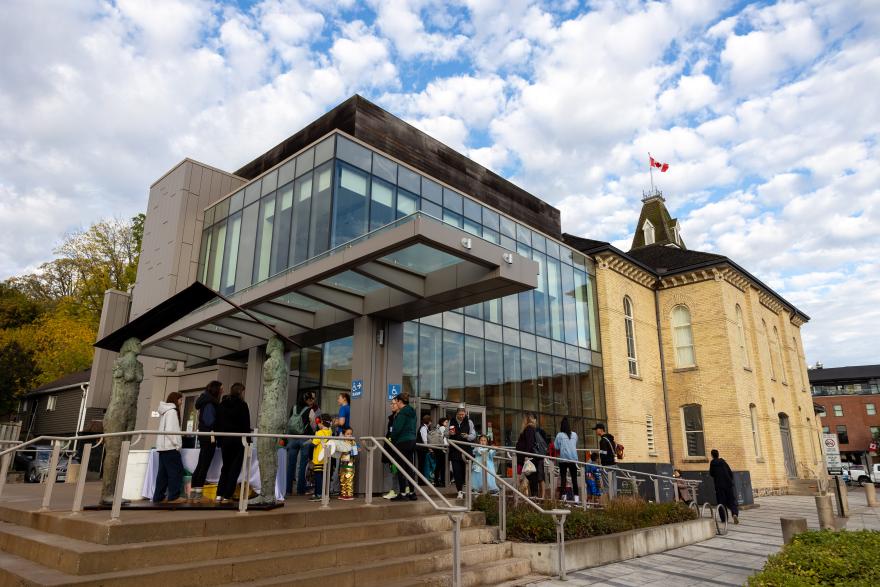 Building with a crowd lining up beside it