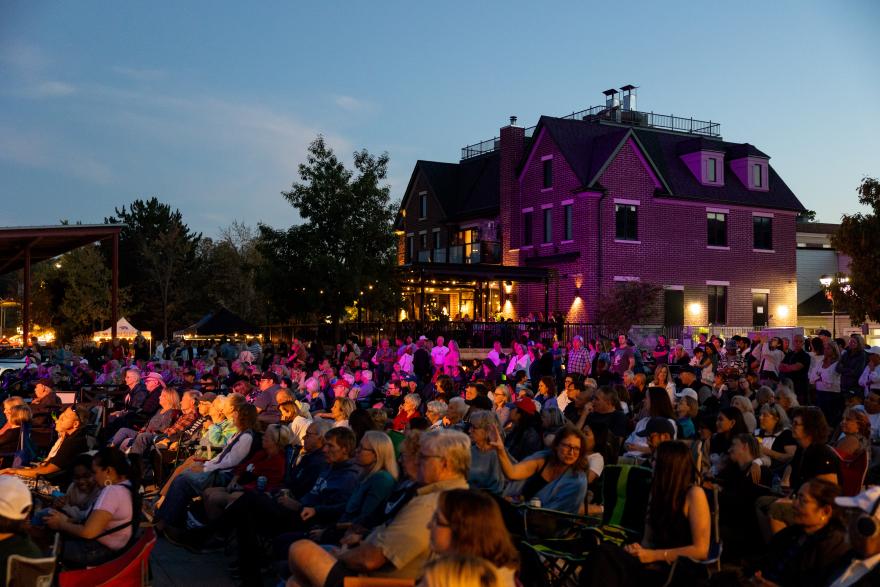 Building with a crowd sitting on it in the evening