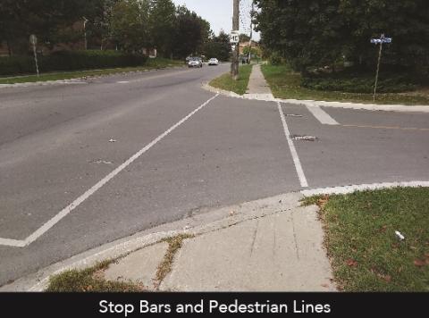 An empty intersection with pedestrian lines.