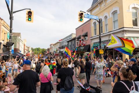 York Pride Festival parade, large crowd walking South down Main Street and Botsford Street