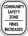 Community safety zone sign with increased fines warning.