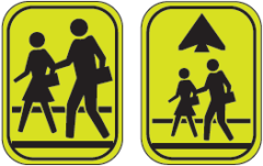 Two yellow pedestrian crossing warning signs with figures walking.
