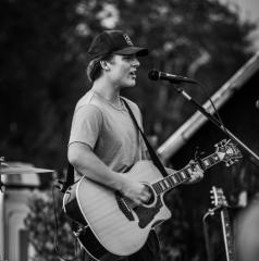 man playing acoustic guitar