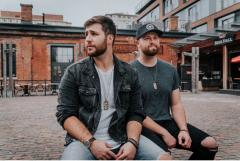 photo of two men sitting 