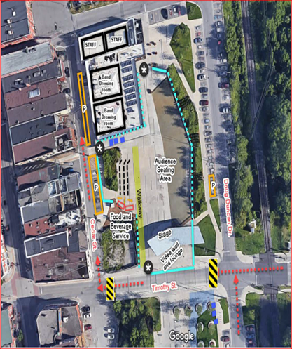 Aerial view of a city block with buildings, roads, and green areas marked.
