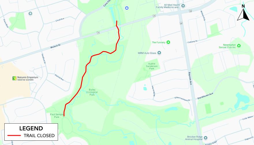 Map showing a trail marked in red as closed through a green park area.