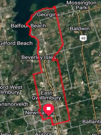 Map with a red outline marking an area, showing towns and roads.